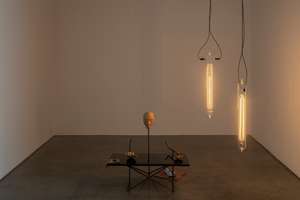 Simon Starling, As he buffs the black lacquered table top to a mirror finish with the  powdered palm of his hand, the artist cat