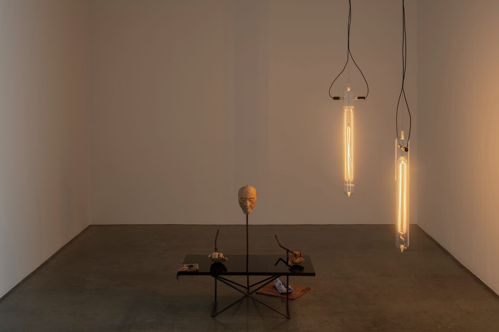 Simon Starling, As he buffs the black lacquered table top to a mirror finish with the  powdered palm of his hand, the artist cat